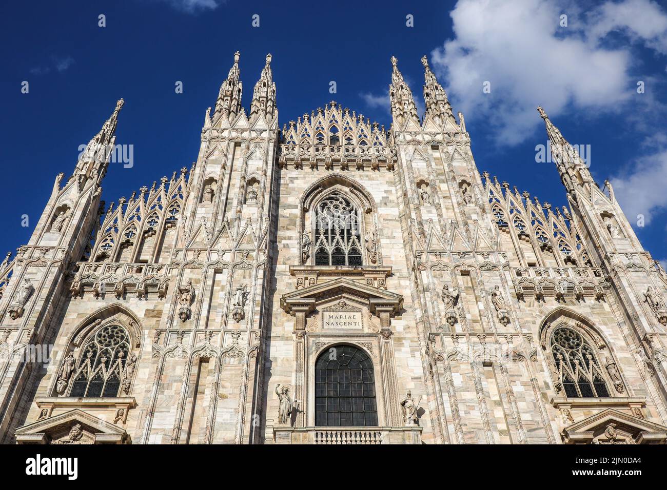 Front View of Milan Cathedral in Northern Italy. Below View of Metropolitan Cathedral-Basilica of the Nativity of Saint Mary in Lombardy with Blue Sky Stock Photo