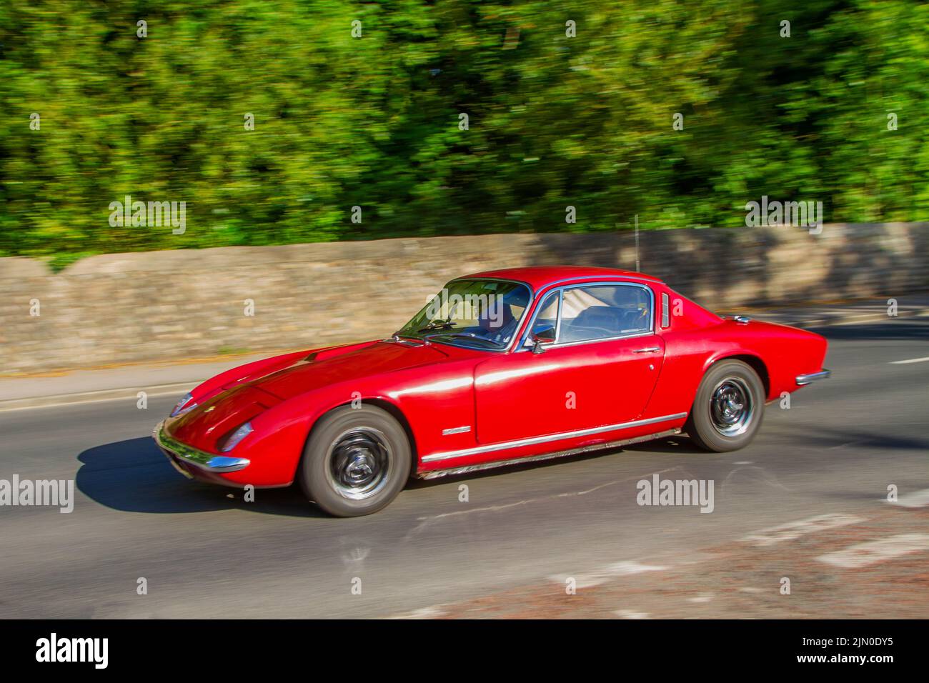 1968 60s sixties, red Lotus ELAN +2 1588cc British petrol sports car; Cars and motorcycles on display at the 13th Lytham Hall Summer Classic Car & Motorcycle Show, a Classic Vintage Collectible Transport Festival. Stock Photo