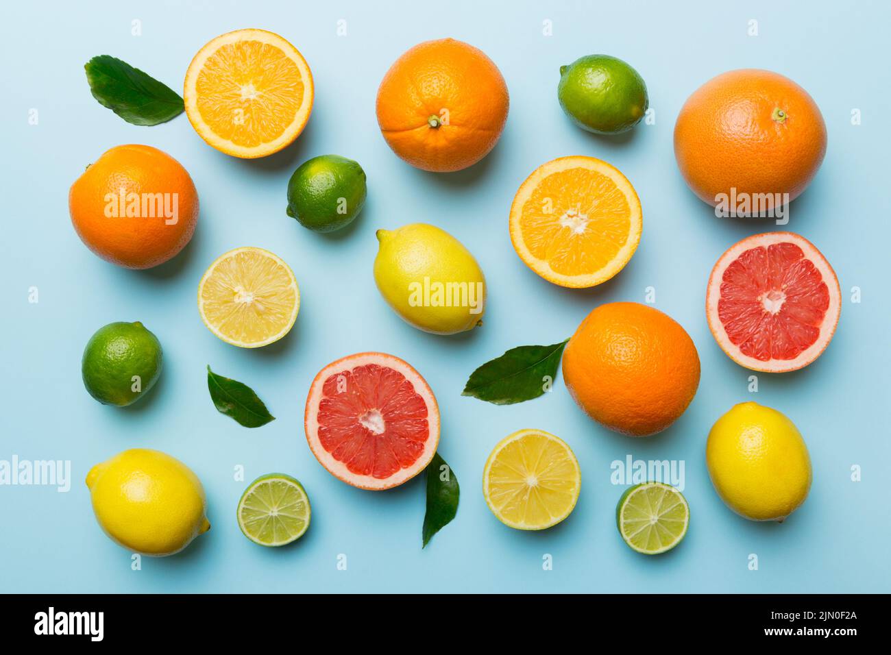 Flat lay of citrus fruits like lime, orange and lemon with lemon tree ...