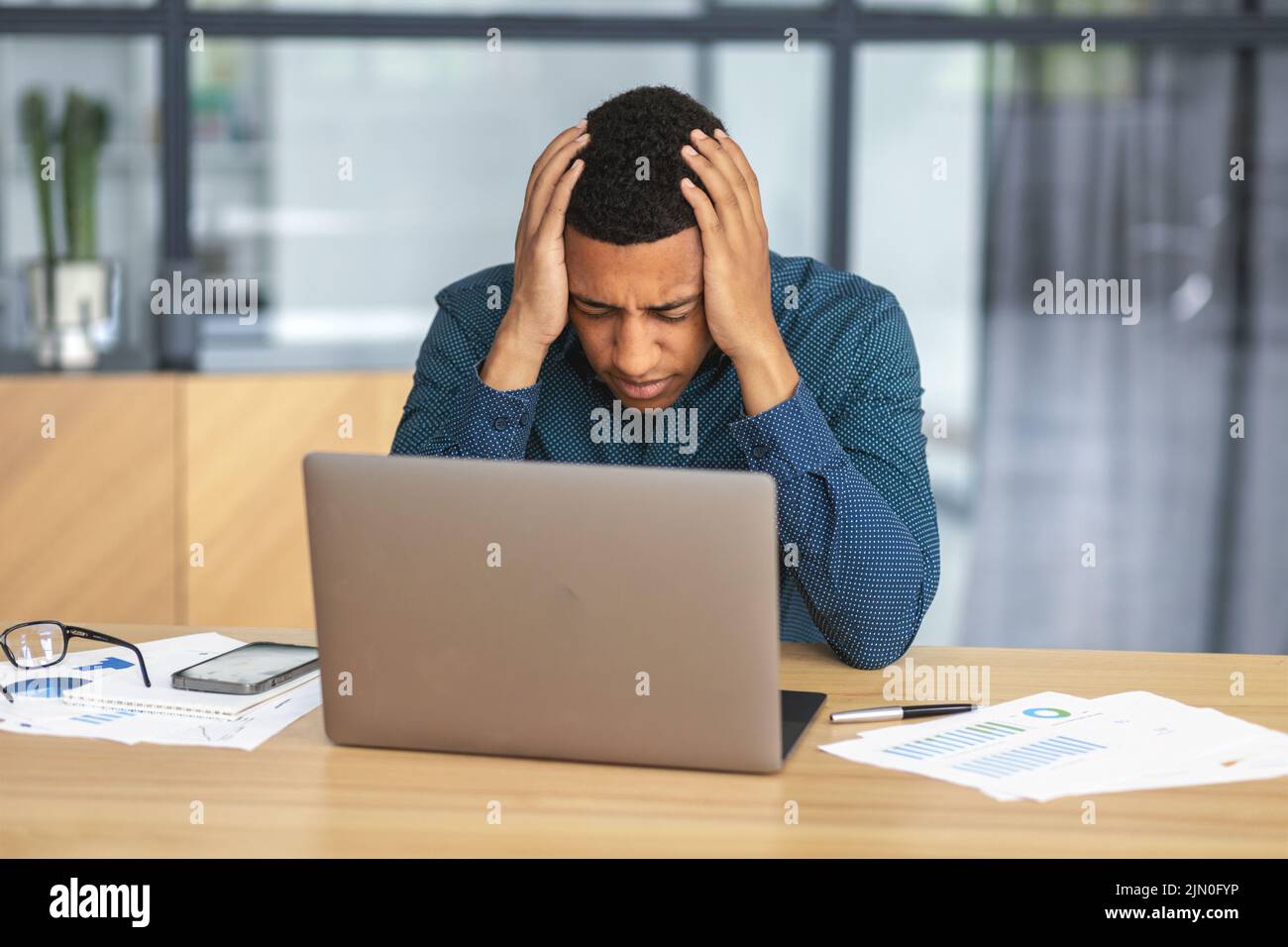 African American man is in sorrow because of his dismissal Young businessman upset by bankruptcy Stock Photo