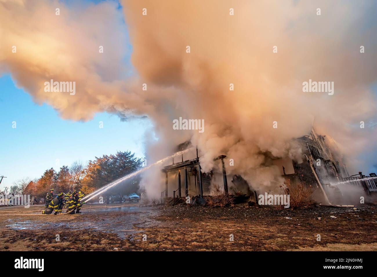 Teams of firefighters work to extinguish the fire as shortly before 6:00 a.m. on Saturday, March 8th, 2014 the Bridgehampton Fire Department was calle Stock Photo