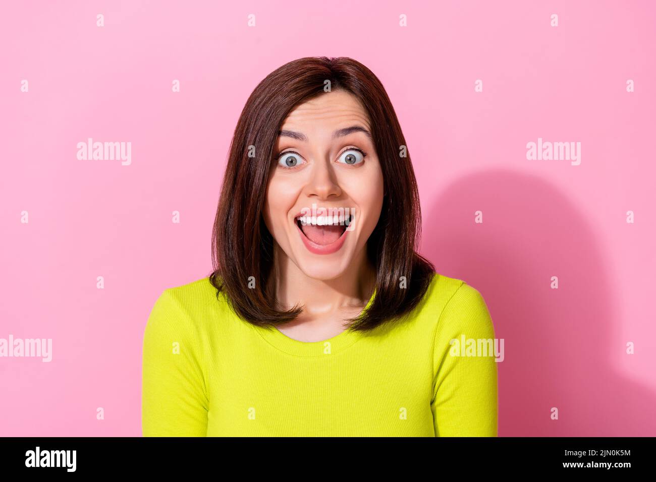 Photo of cheerful overjoyed girl open mouth speechless cant believe isolated on pink color background Stock Photo