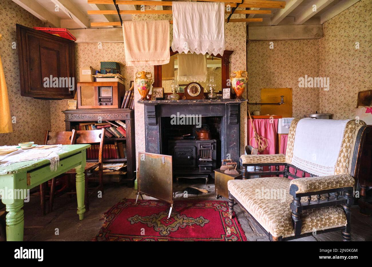 A dining, living area with dish cooking fireplace and hanging
