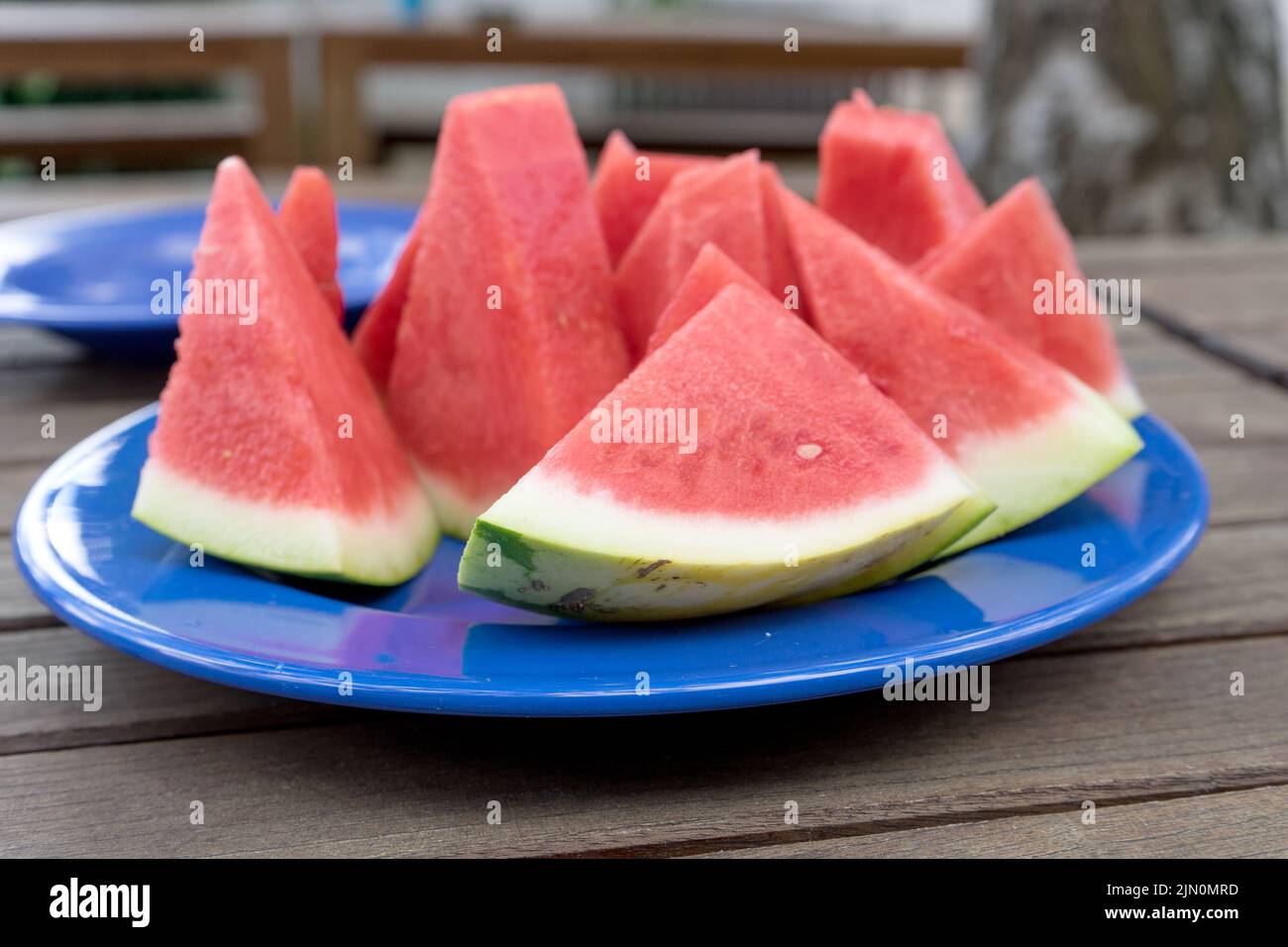Pieces of melon on a blue plate Stock Photo