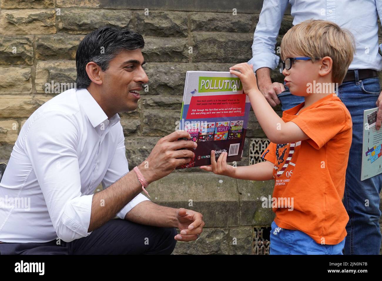 Rishi Sunak (left) looks at a book with Teddy Openshaw, four, from Whitewell, following an event in Ribble Valley, held as part of his campaign to be leader of the Conservative Party and the next prime minister. Picture date: Monday August 8, 2022. Stock Photo