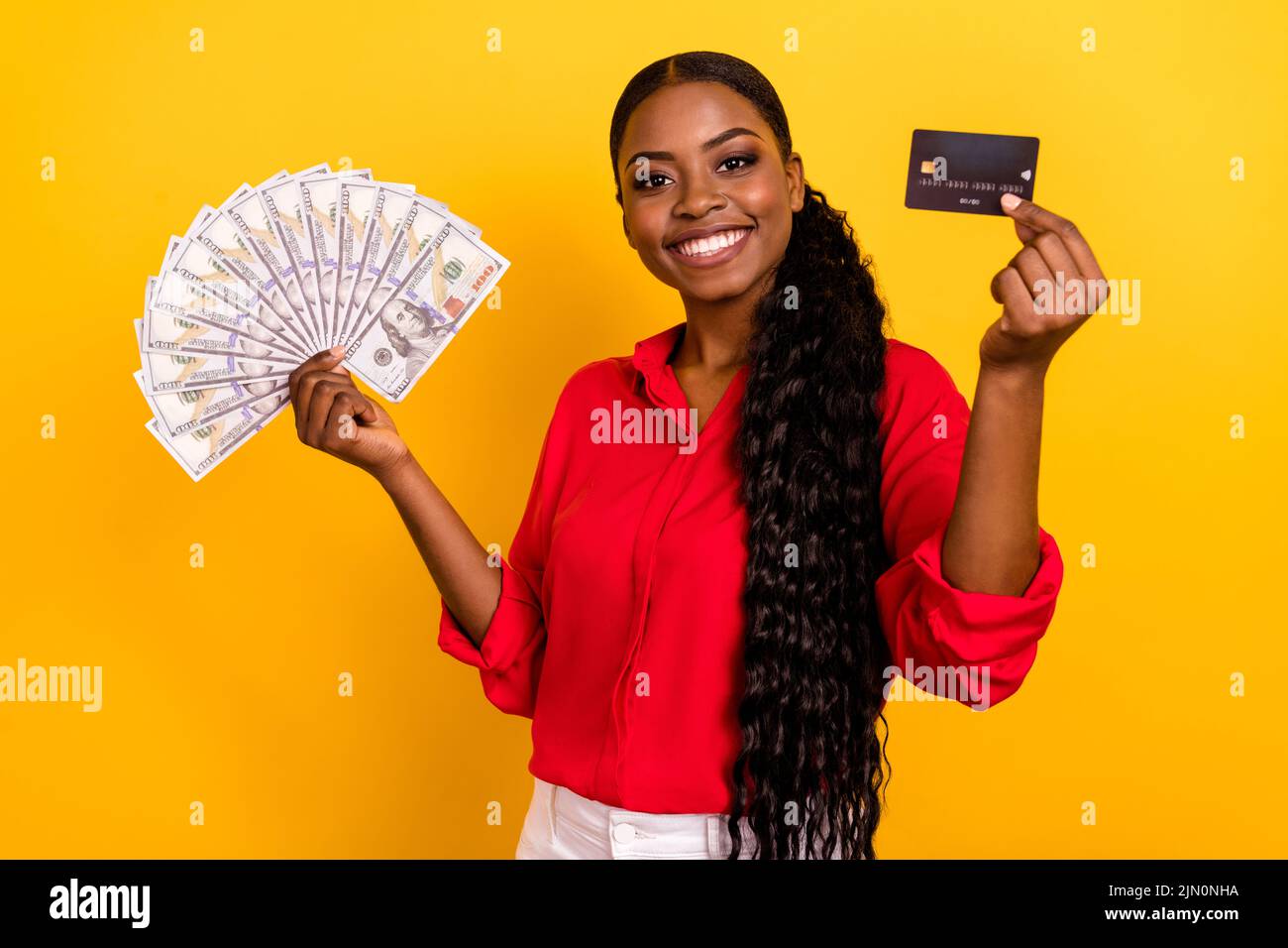 Photo of young pretty girl rich income profit credit card rich investment isolated over yellow color background Stock Photo