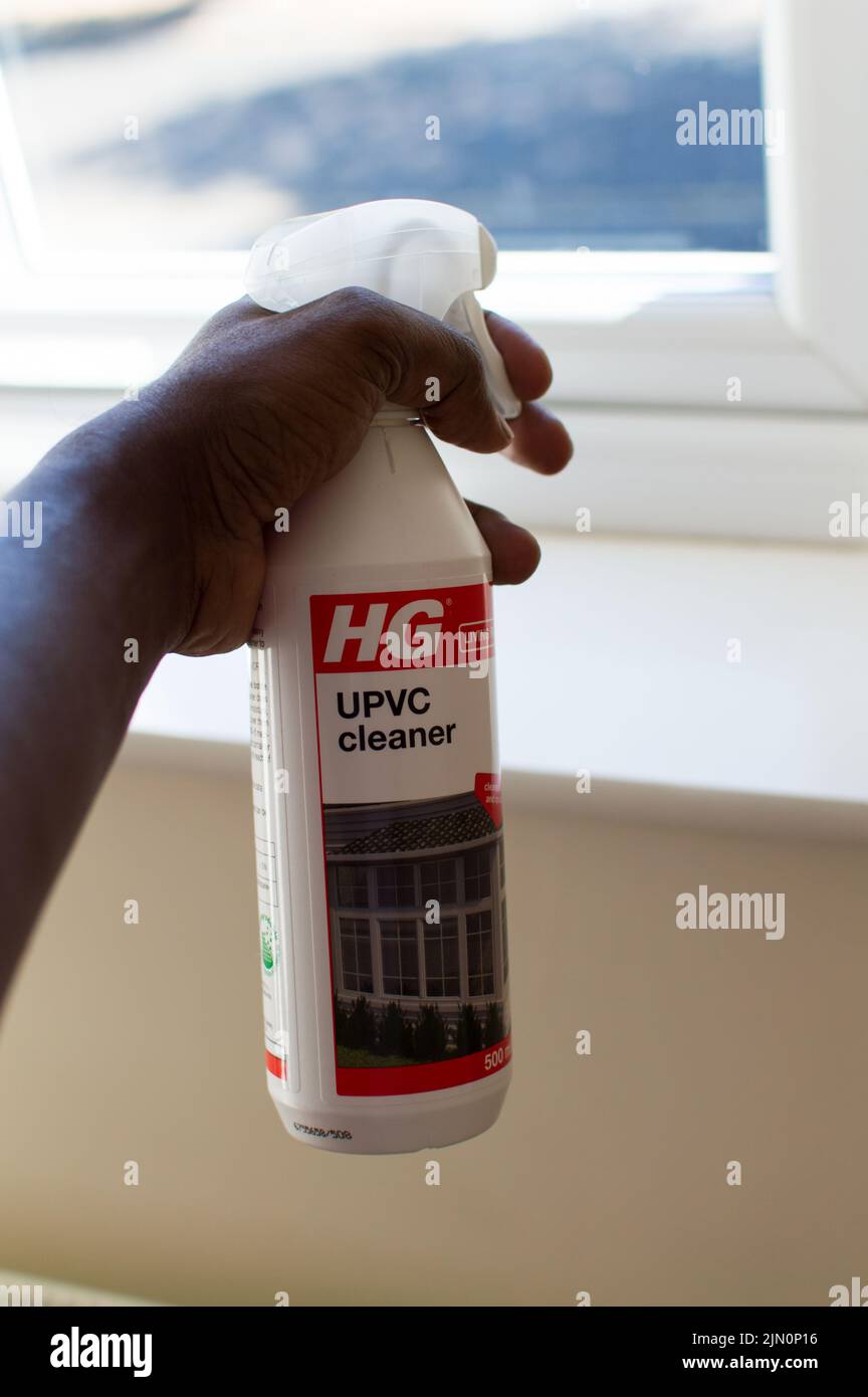 Adult male cleaning UPVC with specialized product Stock Photo
