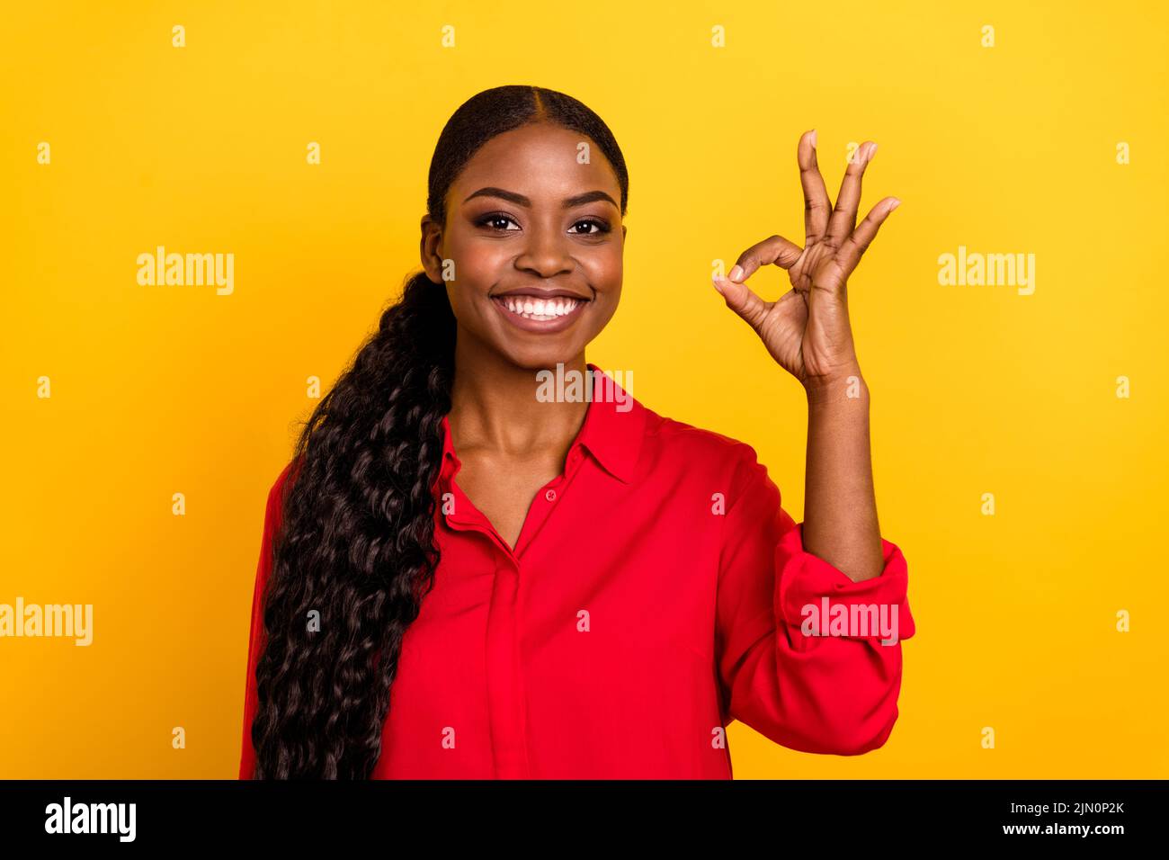 Photo of young lovely girl show fingers okey symbol select suggest promoter isolated over yellow color background Stock Photo