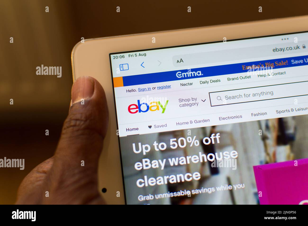Adult male checking eBay app on ipad screen Stock Photo