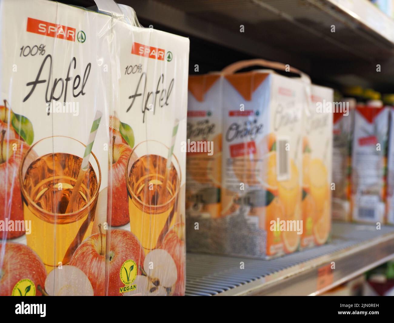 Packets with 100 apple juice on a shelf in a Spar supermarket Stock