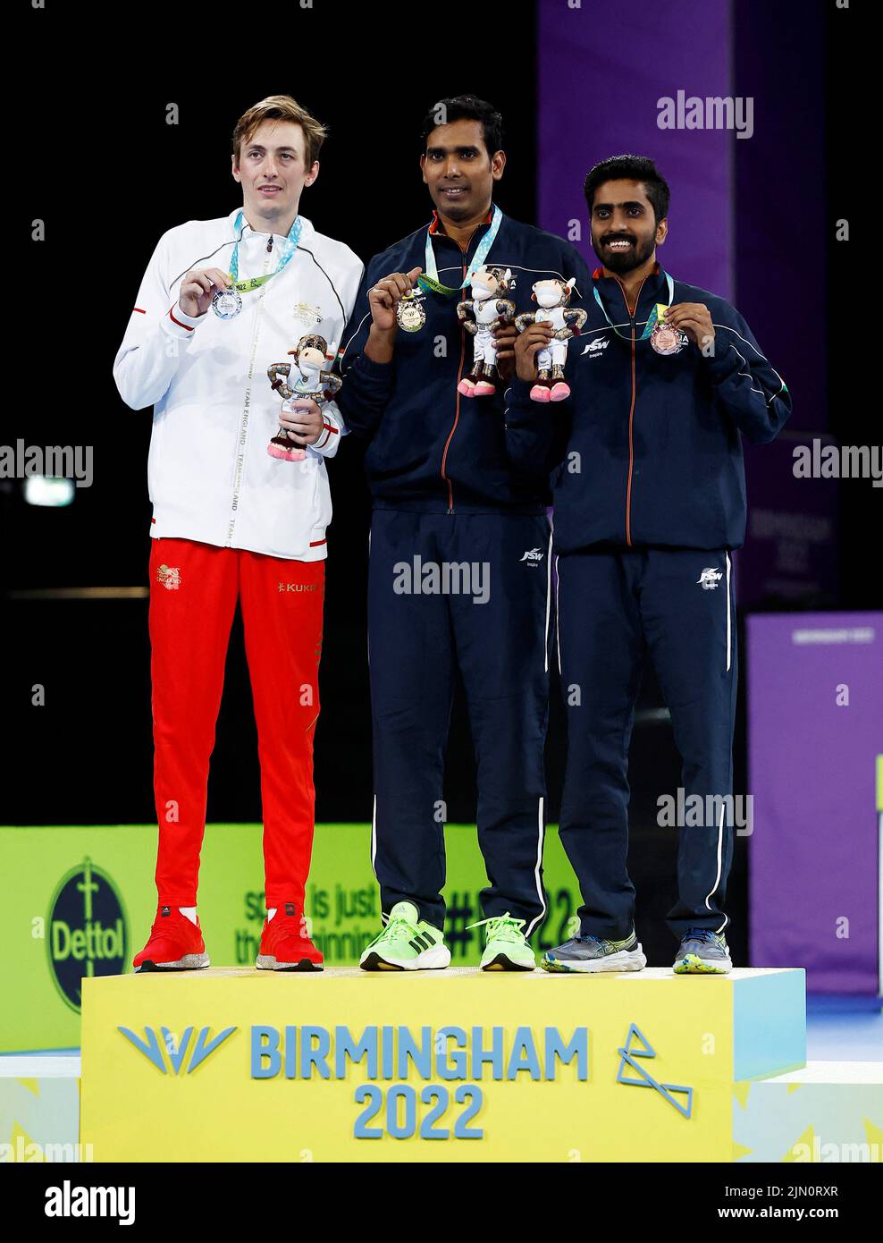 Commonwealth Games - Table Tennis - Men's Singles - Medal Ceremony - The NEC Hall 3, Birmingham, Britain - August 8, 2022 Gold medallist India's Sharath Kamal Achanta celebrates on the podium alongside silver medallist England's Liam Pitchford and bronze medallist India's Sathiyan Gnanasekaran during the medal ceremony REUTERS/Jason Cairnduff Stock Photo