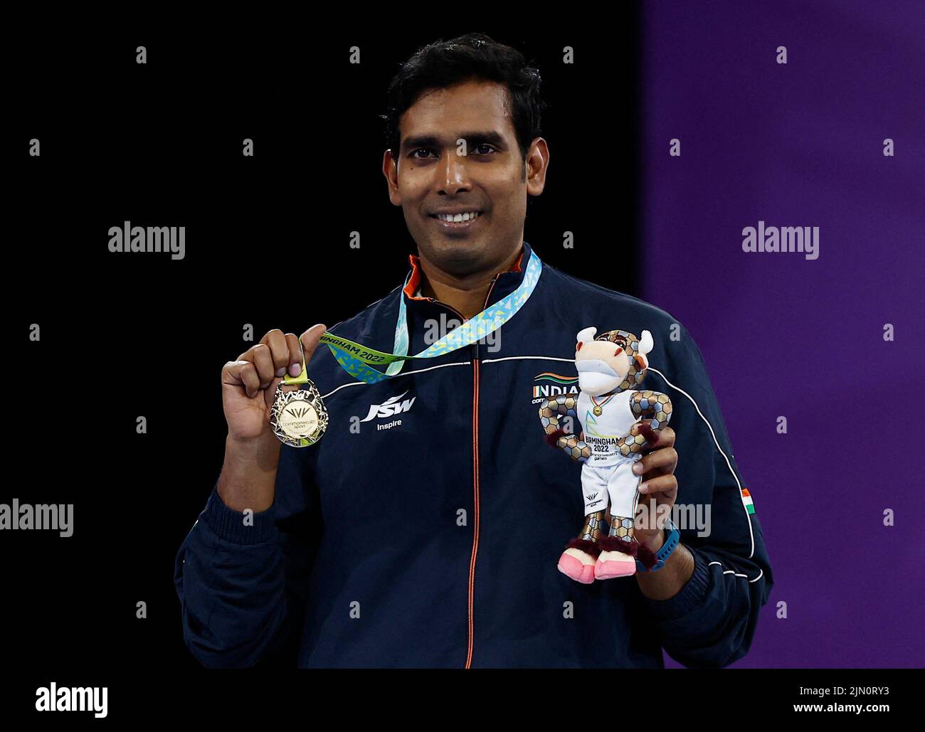 Commonwealth Games - Table Tennis - Men's Singles - Medal Ceremony - The NEC Hall 3, Birmingham, Britain - August 8, 2022 Gold medallist India's Sharath Kamal Achanta celebrates on the podium during the medal ceremony REUTERS/Jason Cairnduff Stock Photo