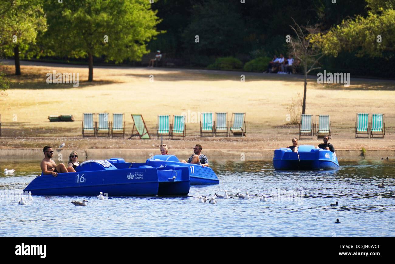 Pedalo riders traverse the Boating Lake in Regents Park, London
