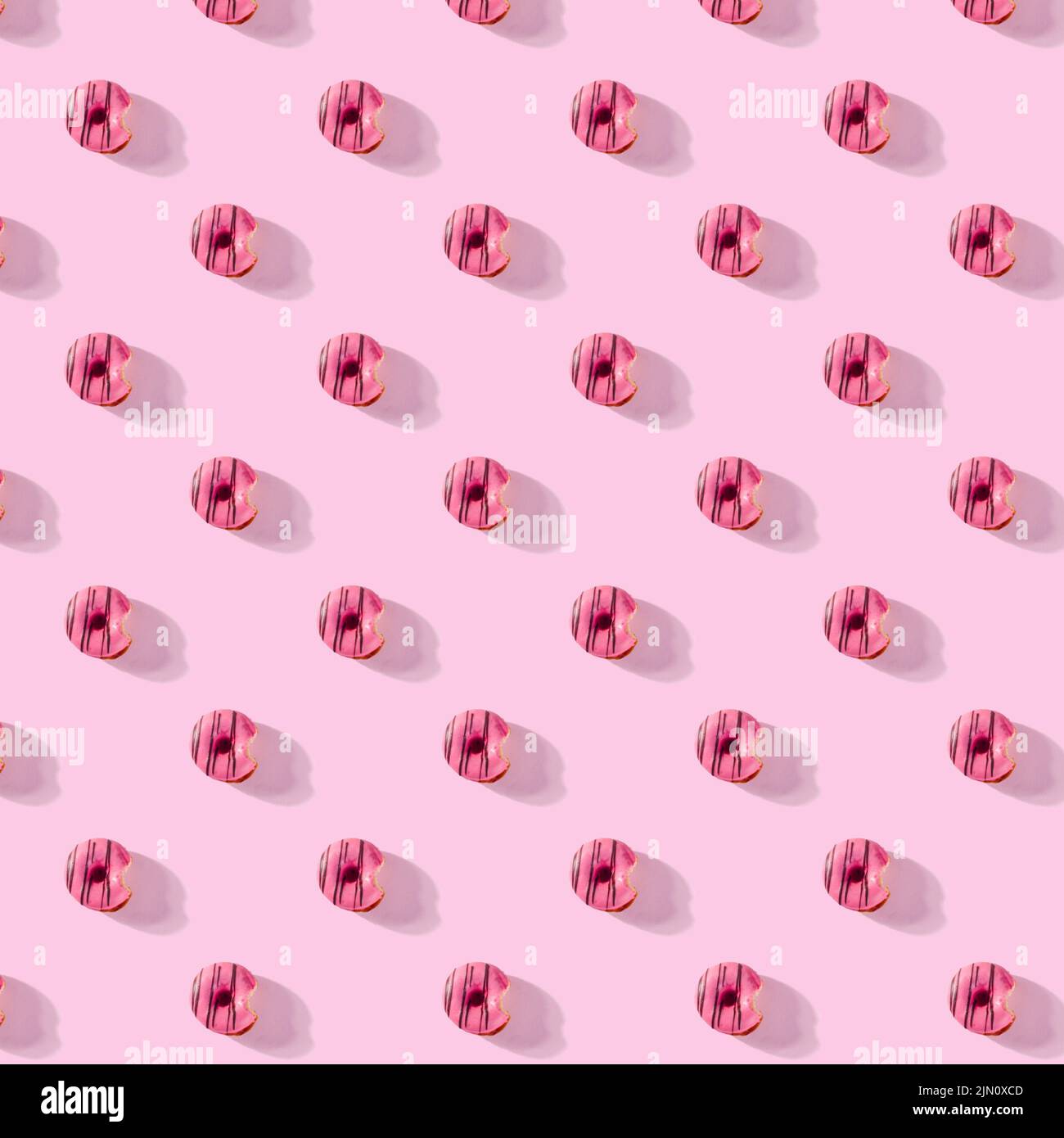 pattern made of Freshly baked donuts for breakfast on a pink background . Sweet background. Bakery, baking concept. Stock Photo
