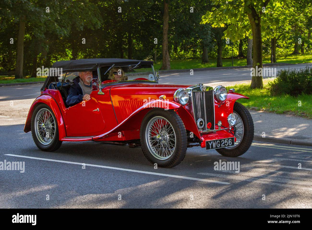 1949, 40s, forties red MG 1250cc petrol Cabrio, Collectable cars are travelling to display at the 13th Lytham Hall Summer Classic Car & Motorcycle Show, a Classic Vintage Collectible Transport Festival. Stock Photo