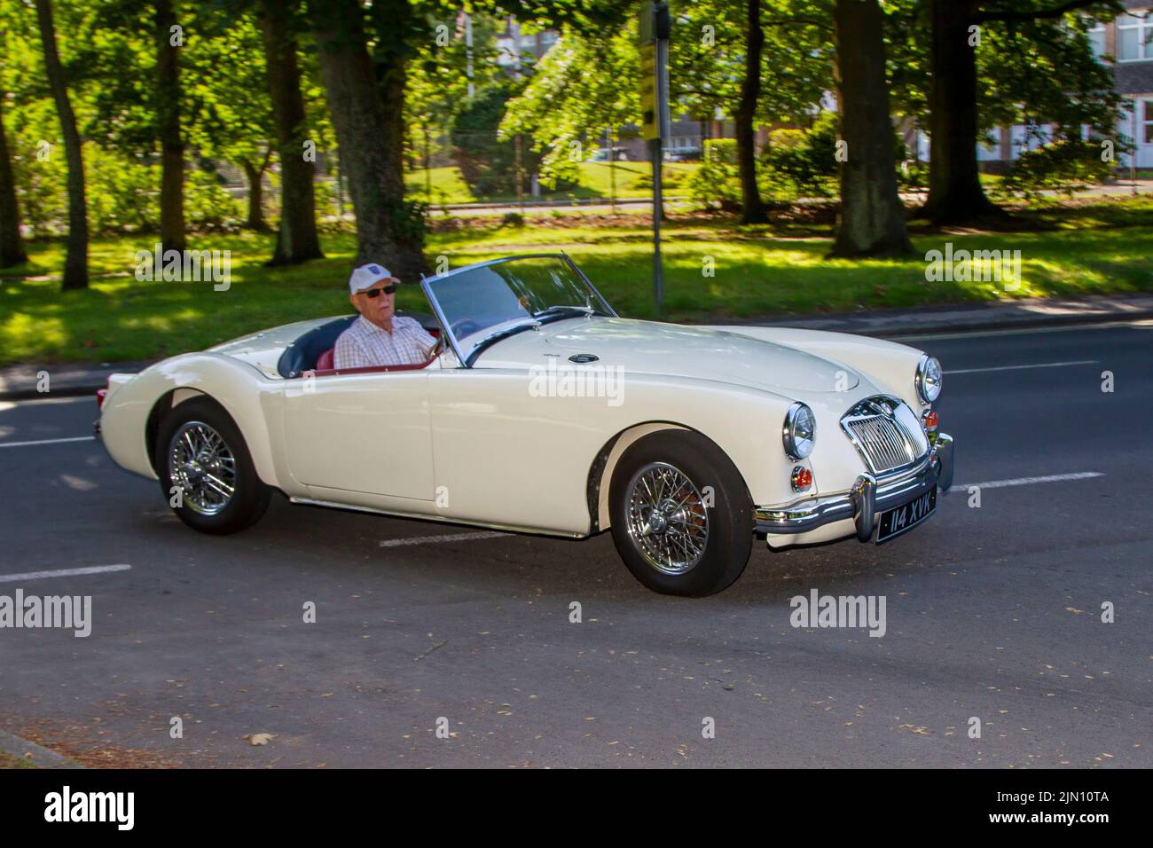 1960 60s, sixties white MG A 1600cc British sports car; Collectable cars are travelling to display at the 13th Lytham Hall Summer Classic Car & Motorcycle Show, a Classic Vintage Collectible Transport Festival. Stock Photo