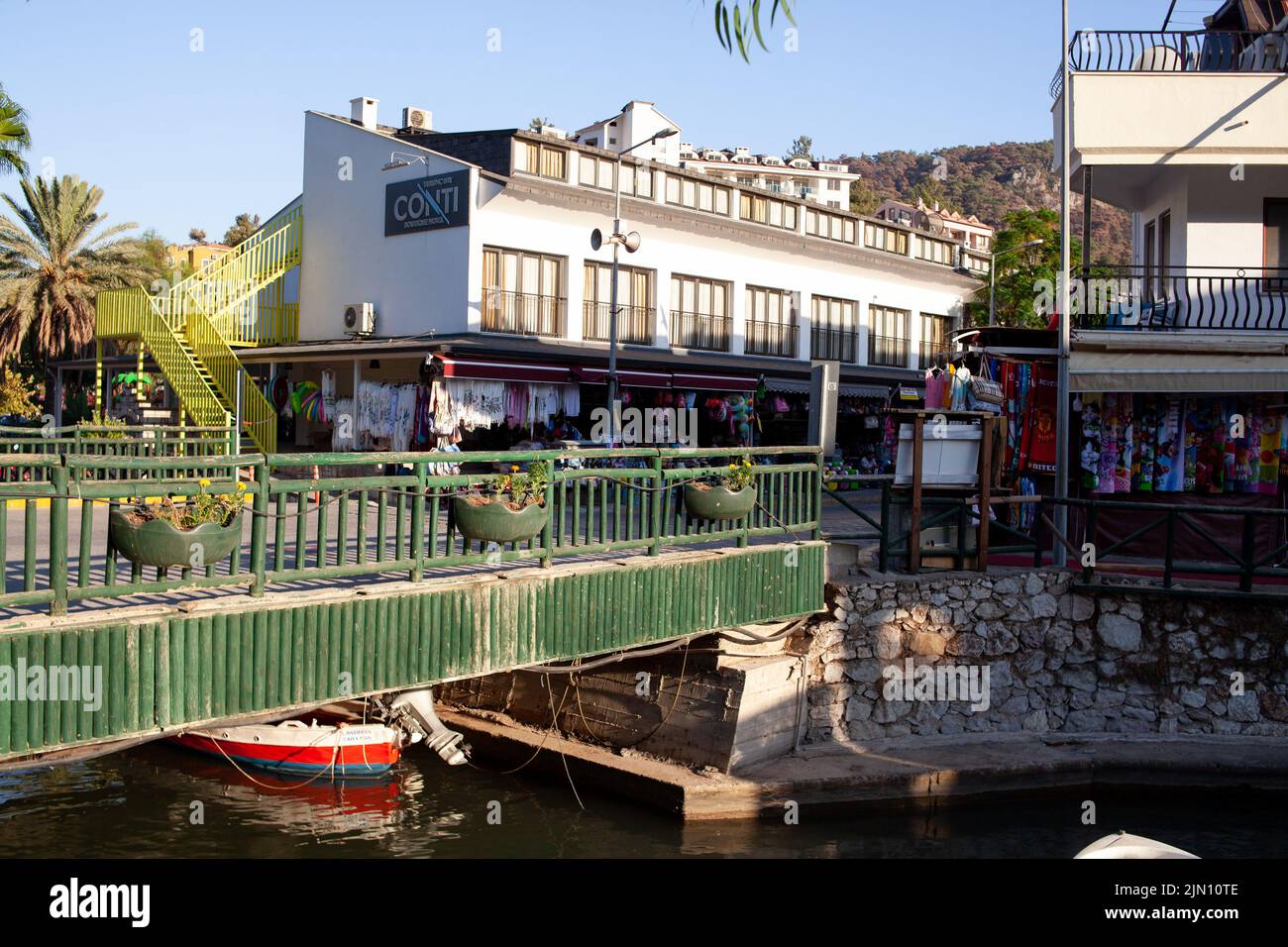 Souvenir and textile shops on picturesque street of resort village. Touristic street in Turkish town. Turunc, Turkey - September 7, 2022. Stock Photo