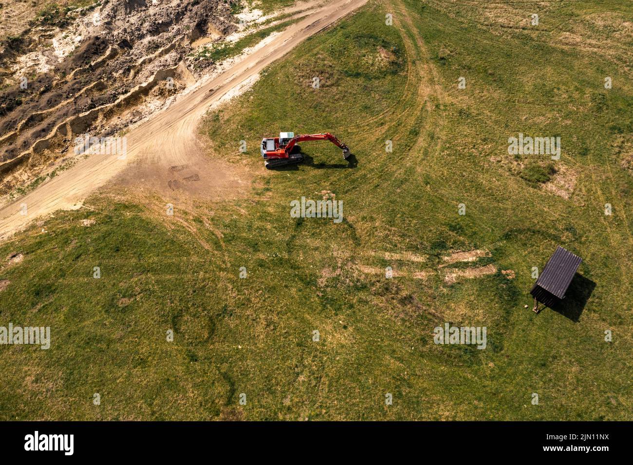Excavator machinery on archeological site, aerial shot from drone pov, high angle view Stock Photo