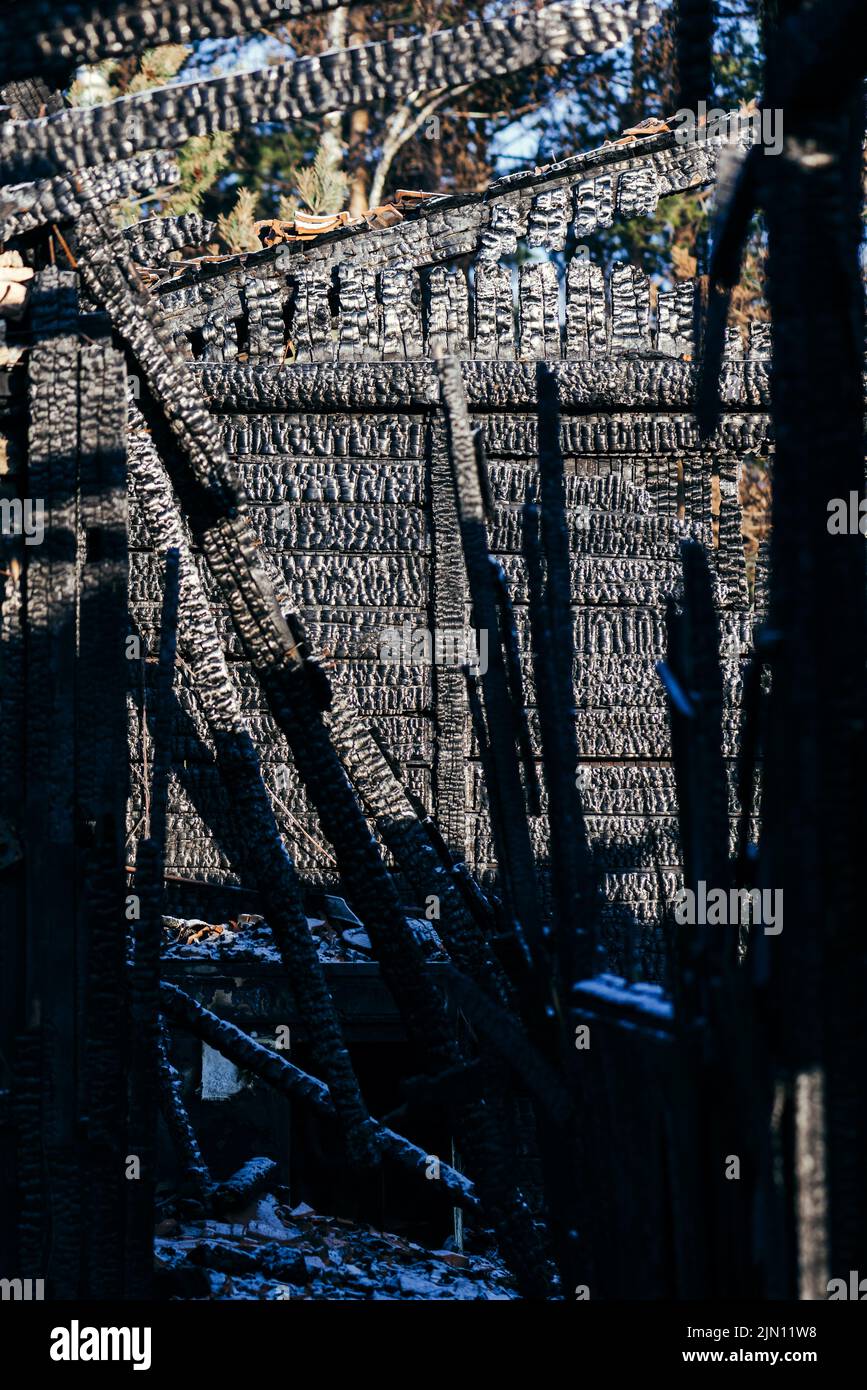 Detail of burnt wooden structure of a house after the fire blaze, selective focus Stock Photo
