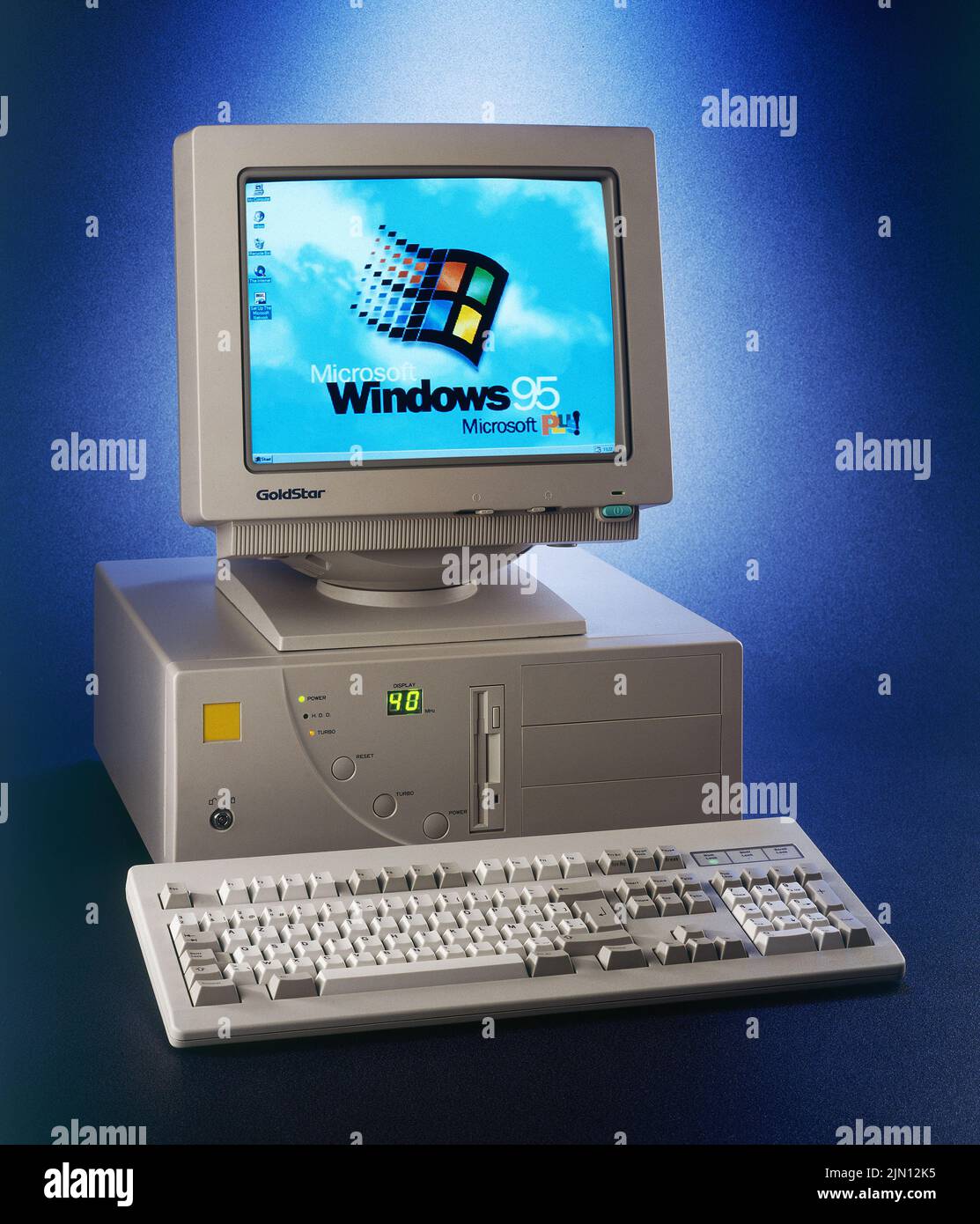 Brussels, Belgium - August 02, 2022:  Nineties obsolete tower pc computer and Windows 95 logo on screen. A old operating system from Microsoft Stock Photo