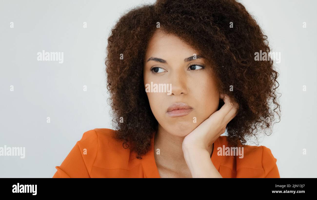 Sad worried African woman ponder thinking problem feeling anxiety depression upset frustrated lonely curly haired pensive girl lady grief troubled Stock Photo