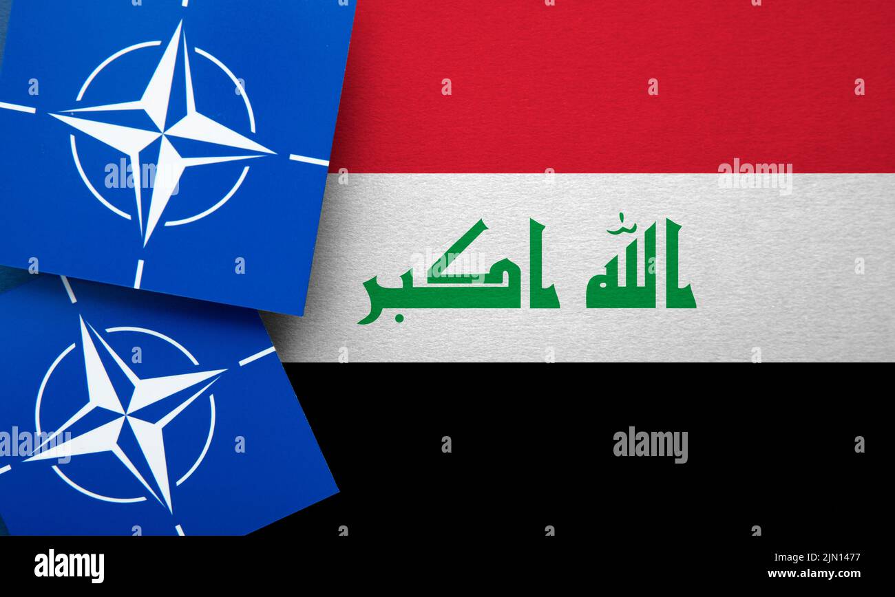 LONDON, UK - August 2022: NATO North Atlantic Treaty Organization military alliance logo on a Iraq flag Stock Photo