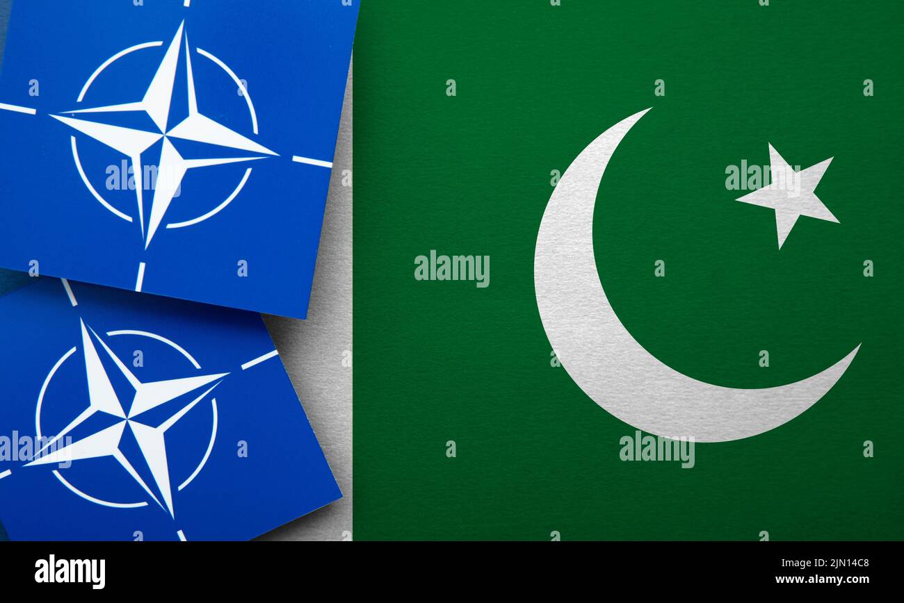 LONDON, UK - August 2022: NATO North Atlantic Treaty Organization military alliance logo on a Pakistan flag Stock Photo