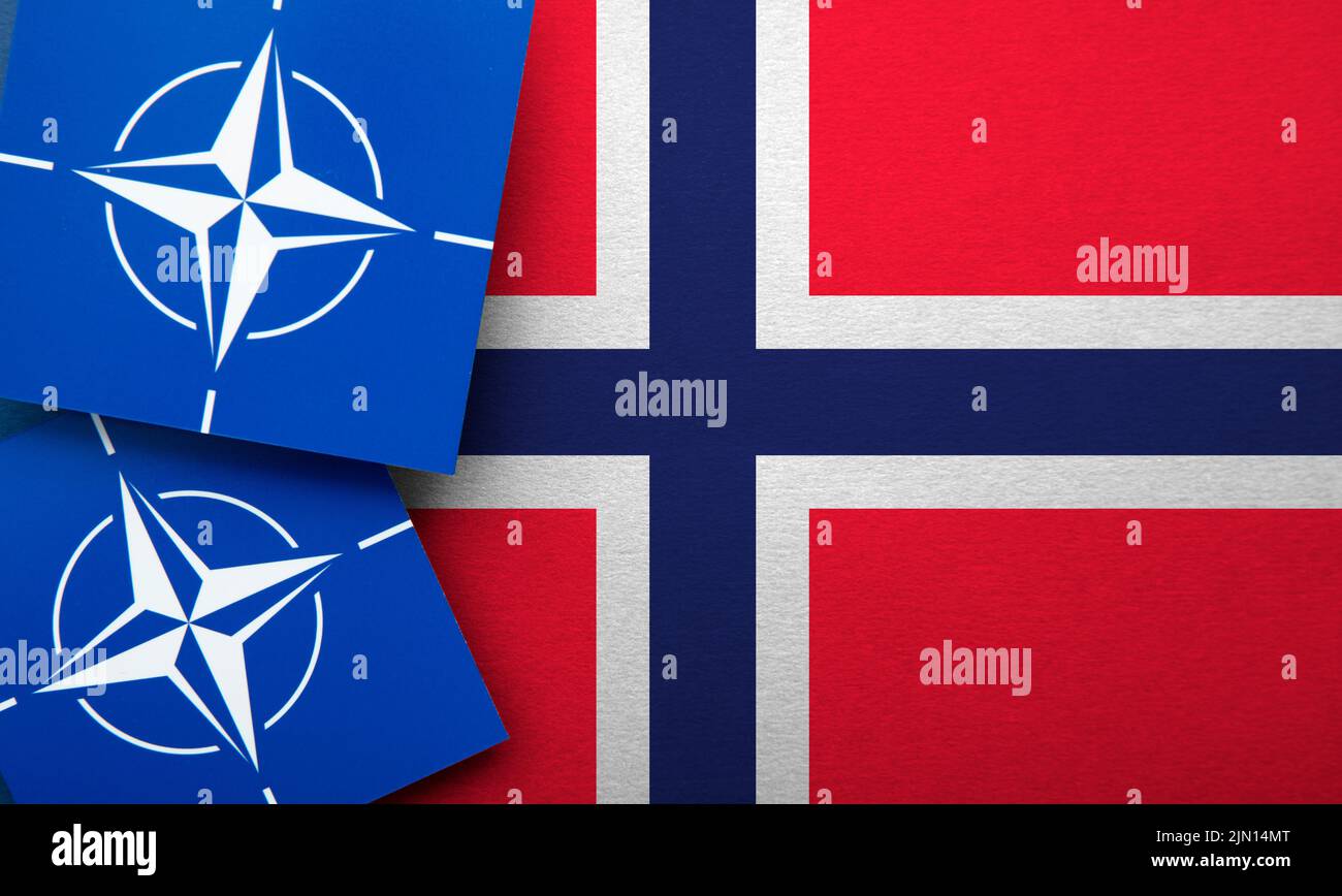 LONDON, UK - August 2022: NATO North Atlantic Treaty Organization military alliance logo on a Norway flag Stock Photo