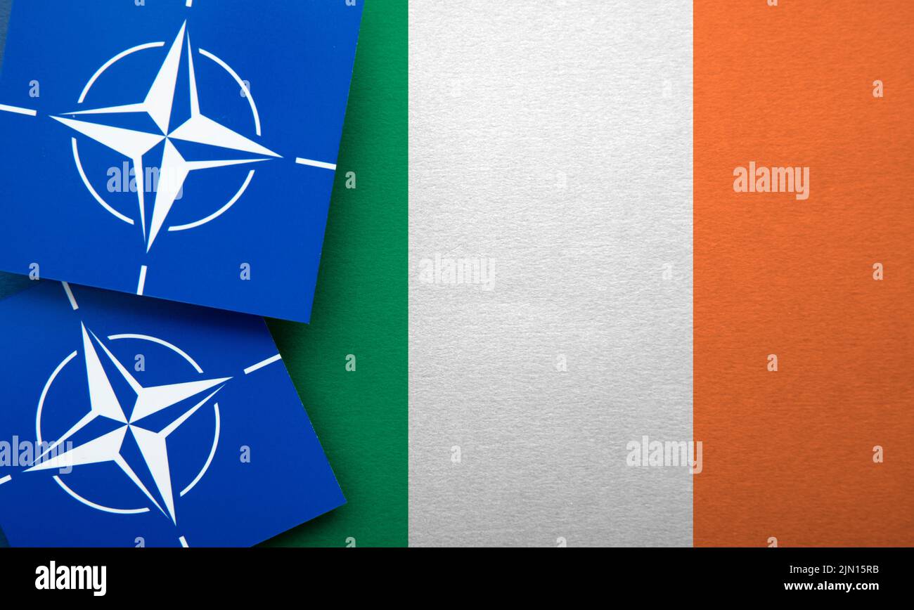 LONDON, UK - August 2022: NATO North Atlantic Treaty Organization military alliance logo on a Ireland flag Stock Photo
