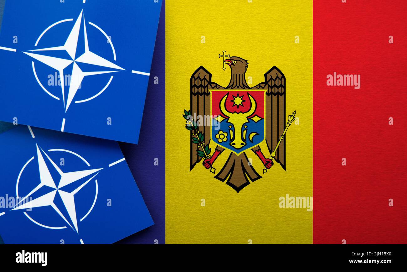 LONDON, UK - August 2022: NATO North Atlantic Treaty Organization military alliance logo on a Moldova flag Stock Photo