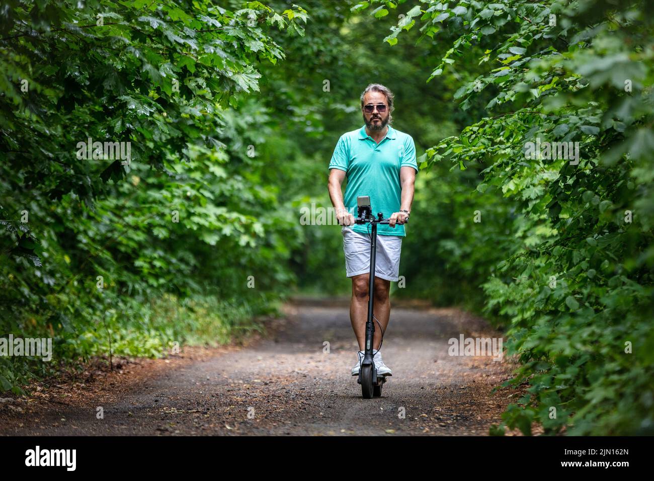 Guy ride on electric scooter hi-res stock photography and images - Alamy