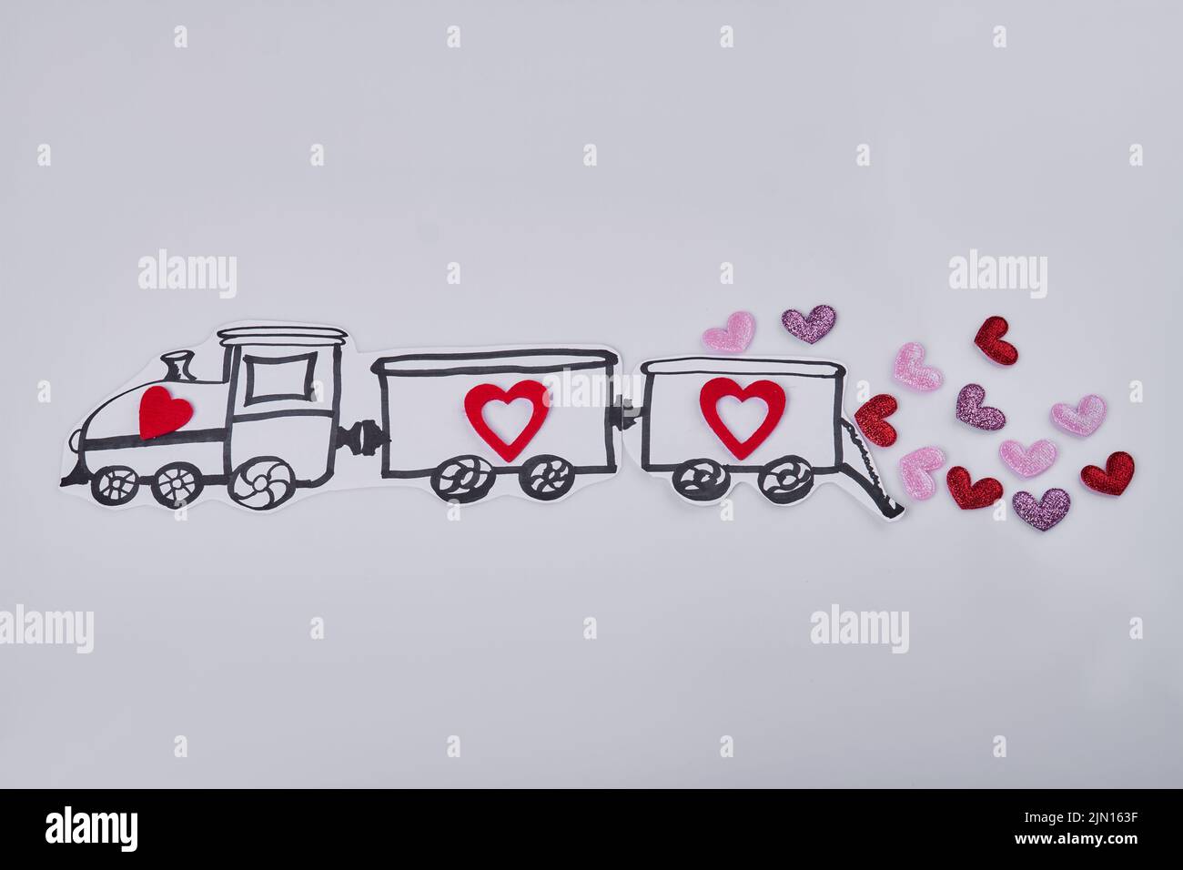 Hand drawn cartoon train with hearts on white background. Abundance of love concept. Stock Photo