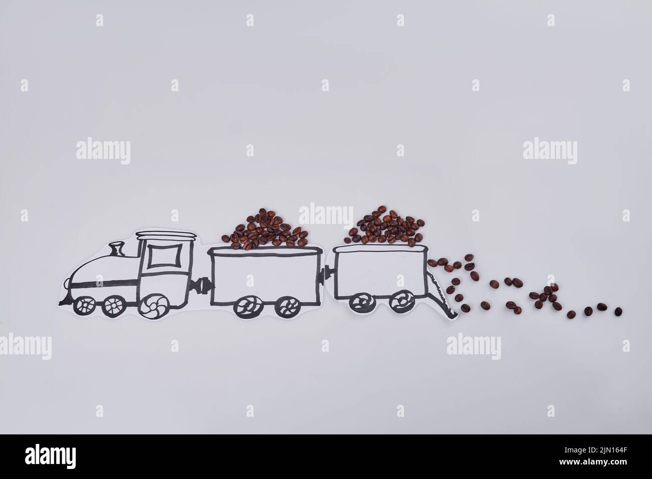 Cartoon train full of coffee beans on white background. Hand drawn locomotive with wagons. Stock Photo