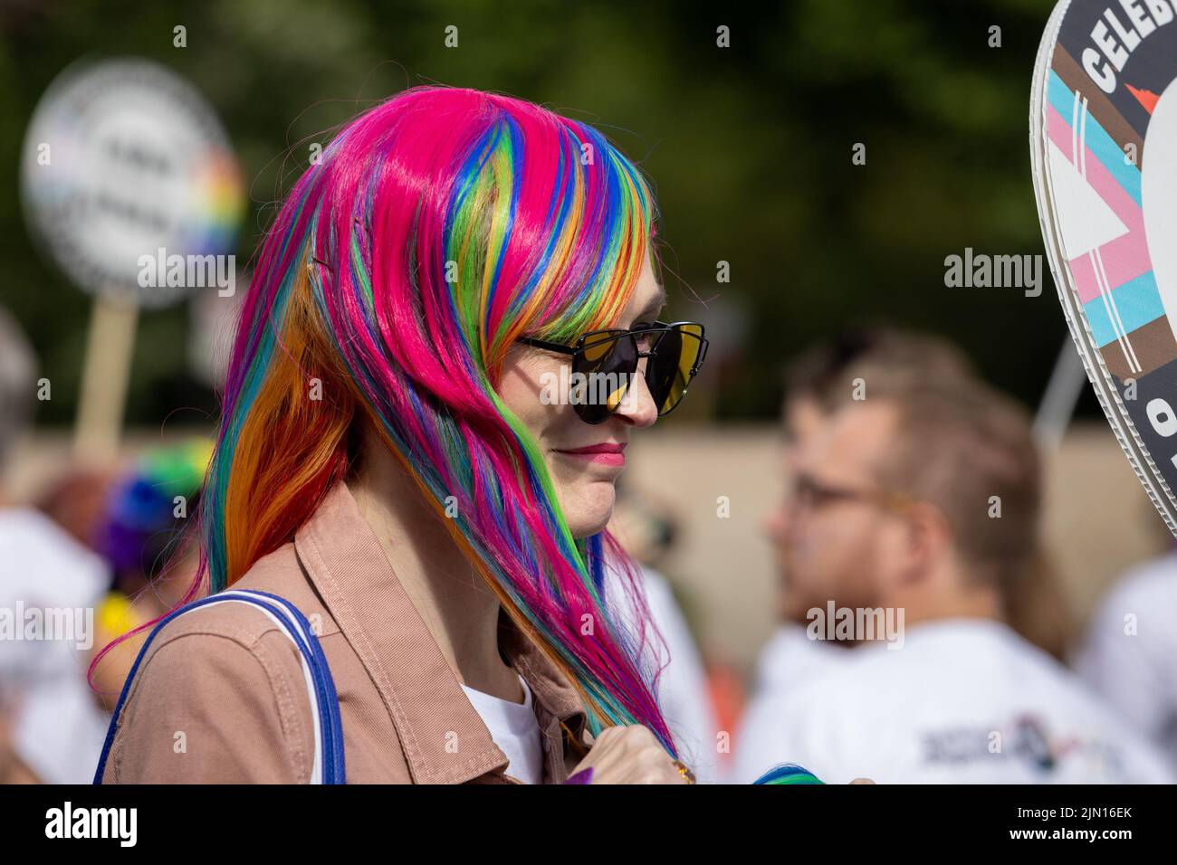 A middle aged woman with pink and rainbow hair marches at London Pride 2022 Stock Photo