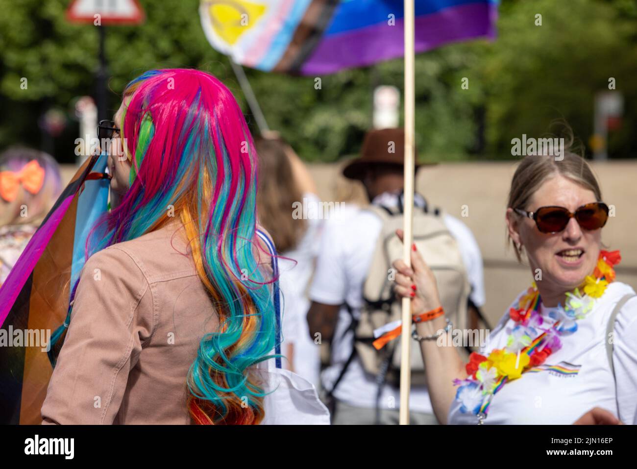 A middle aged woman with pink and rainbow hair marches at London Pride 2022 Stock Photo