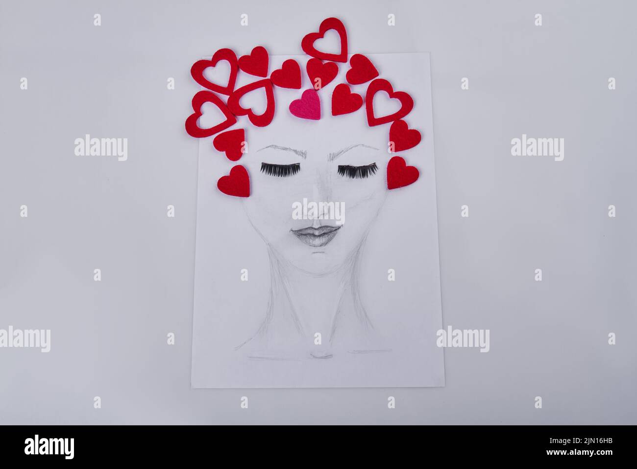 Hand drawn female face with hearts represent her hair. Portrait of woman with eyes closed. Stock Photo