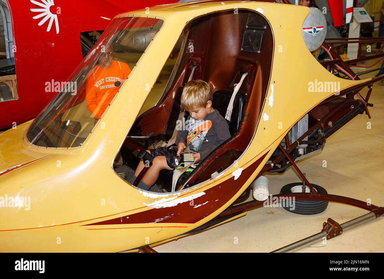 young boy sitting in 2 seat helicopter, adventure, fun, recreation, learning, aircraft, transportation, Helicopter Museum; Pennsylvania; West Chester, Stock Photo