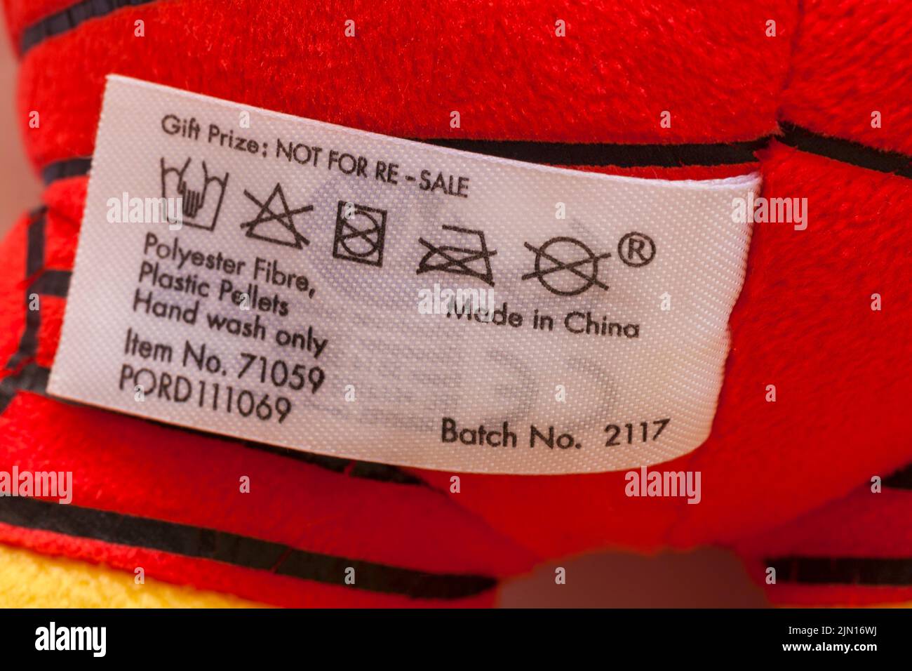 Made in China polyester fibre plastic pellets hand wash only label washing cleaning instructions on label in Marvel Iron Man soft plush toy Stock Photo