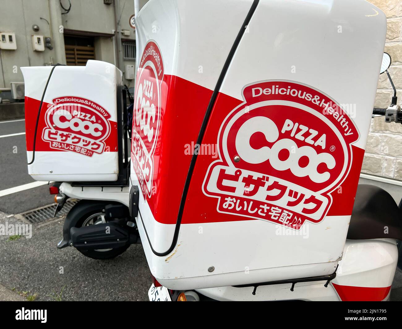 Pizza Cooc delivery moped scooters. Pizza Cooc is a popular pizza chain in Japan. Stock Photo
