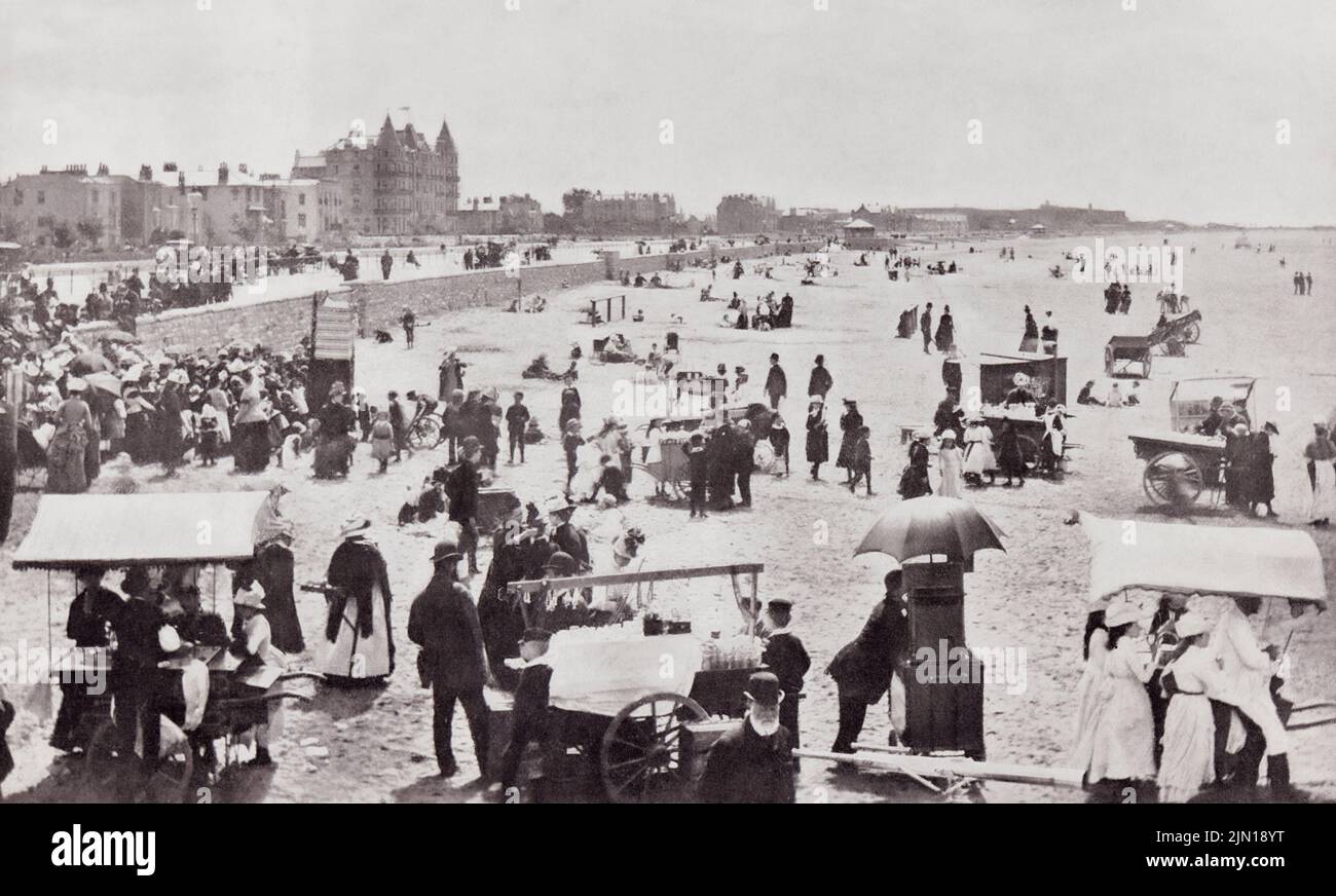Weston-super-Mare, also known as Weston, North Somerset, England.  A summer scene on the sands in the 19th century.  From Around The Coast,  An Album of Pictures from Photographs of the Chief Seaside Places of Interest in Great Britain and Ireland published London, 1895, by George Newnes Limited. Stock Photo