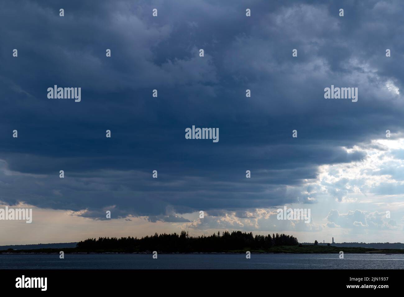 July 8, 2022.  5:47pm.  Storm clouds on the way.  View from Barnes Island.  Casco Bay, Maine. Rain Storm Series. Stock Photo