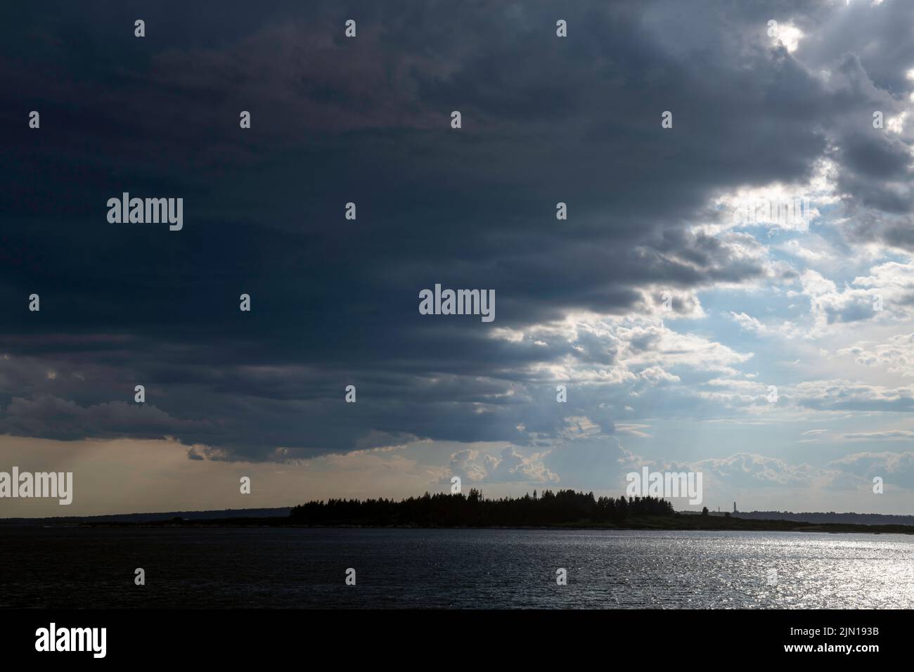 July 8, 2022.  5:55pm.  Storm clouds on the way.  View from Barnes Island.  Casco Bay, Maine. Rain Storm Series. Stock Photo