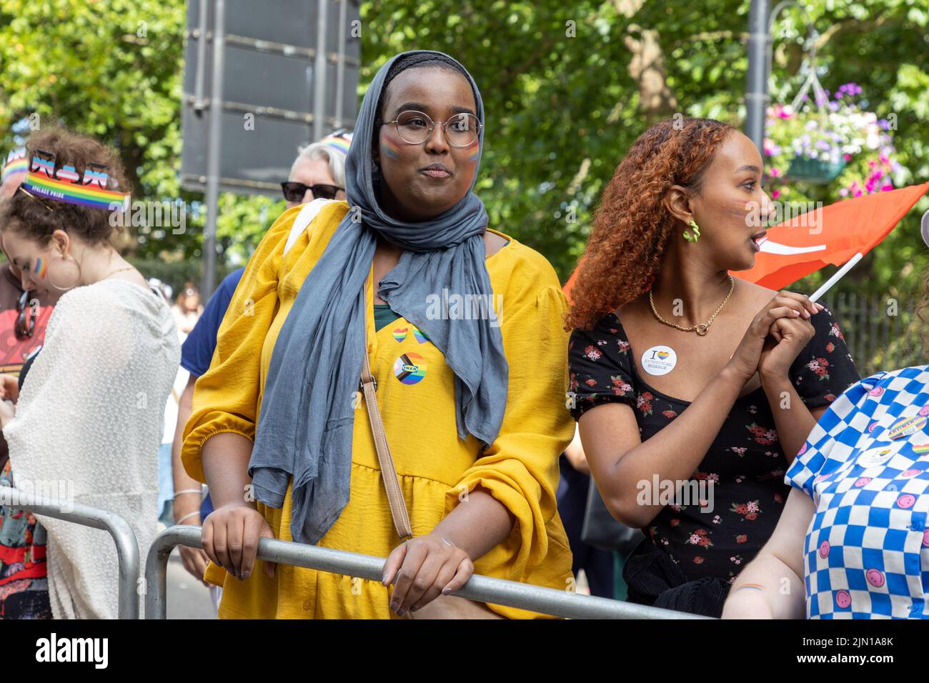 A black muslim lesbian lines the streets of London, Piccadilly at Pride London 2022. the annual march is a celebration for the lesbian, gay, bi-sexual Stock Photo
