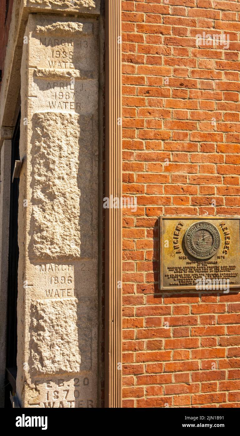 flood levels marks on the side of a building in downtown Hallowell Maine Stock Photo