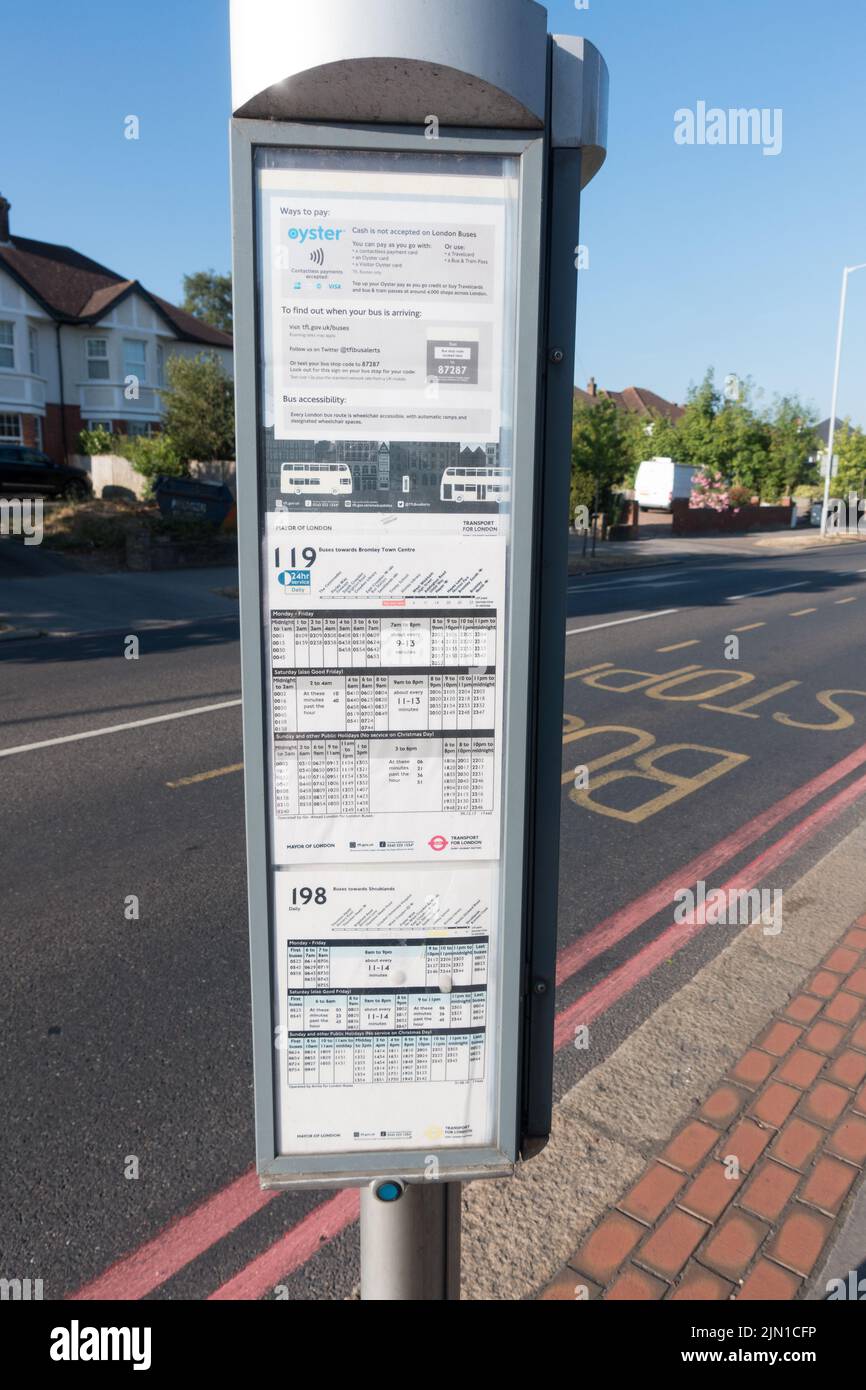 Bus stop with bus timetable Stock Photo