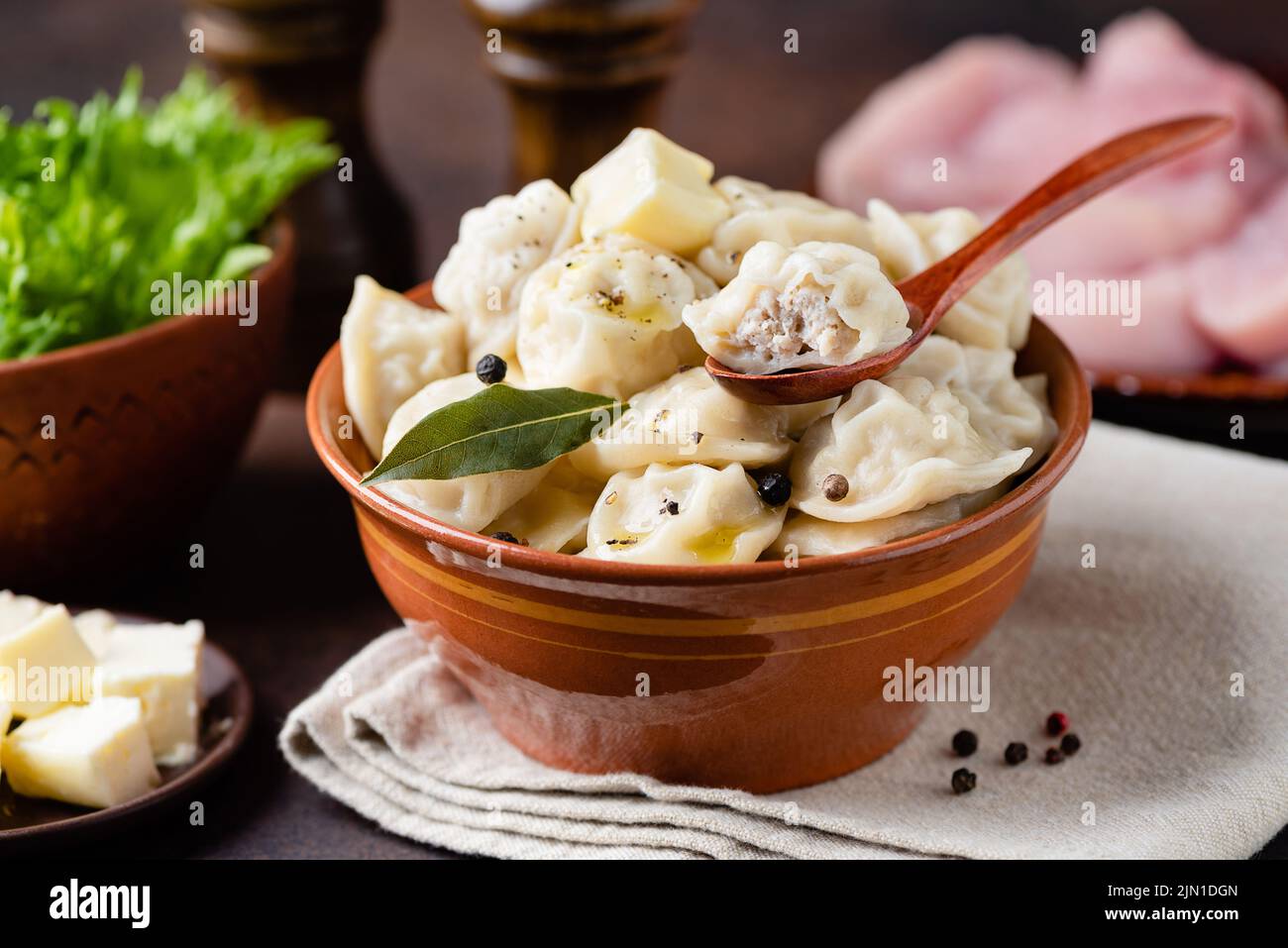 Meat stuffed Dumplings in bowl, Russian Pelmeni, Homemade Food. Wrapped in dough minced meat, similar to italian Tortellini Stock Photo