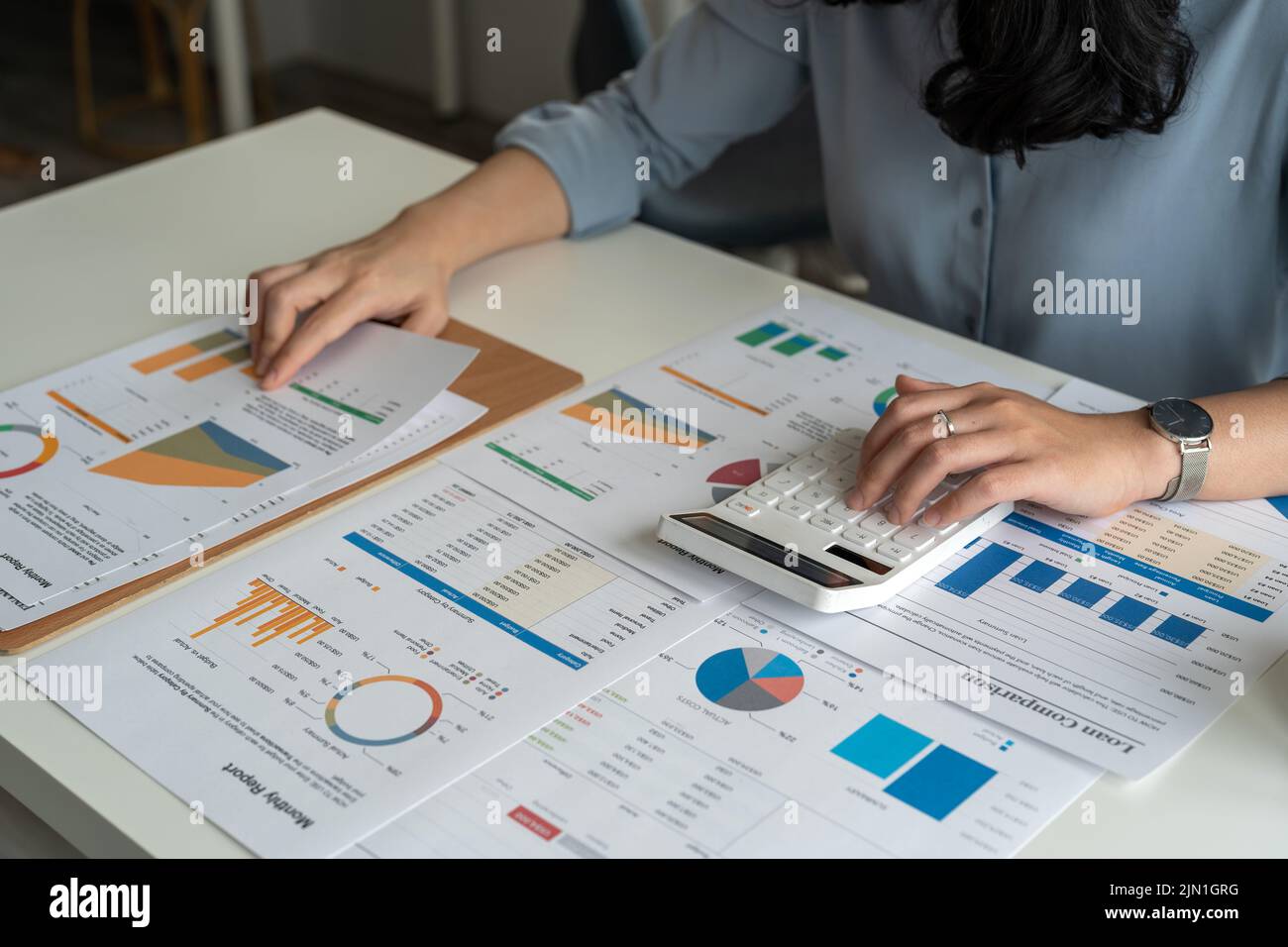 Accounting businesswoman calculating income expenditure and analyzing financial data and tax systems concept.. Stock Photo