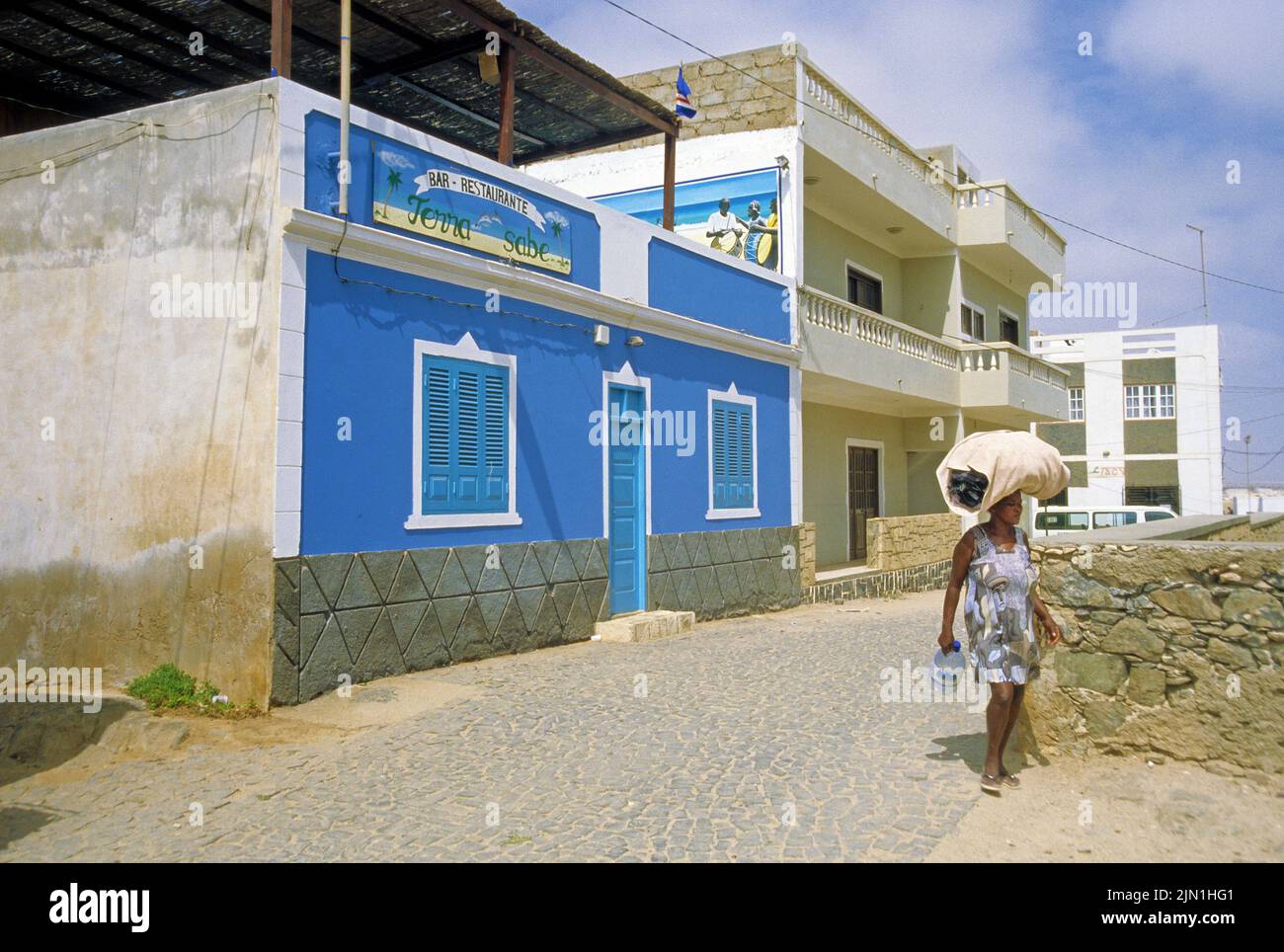 Local woman carrying a bag on her head, Sal Rei, Boavista, Cape Verde Islands, Africa Stock Photo