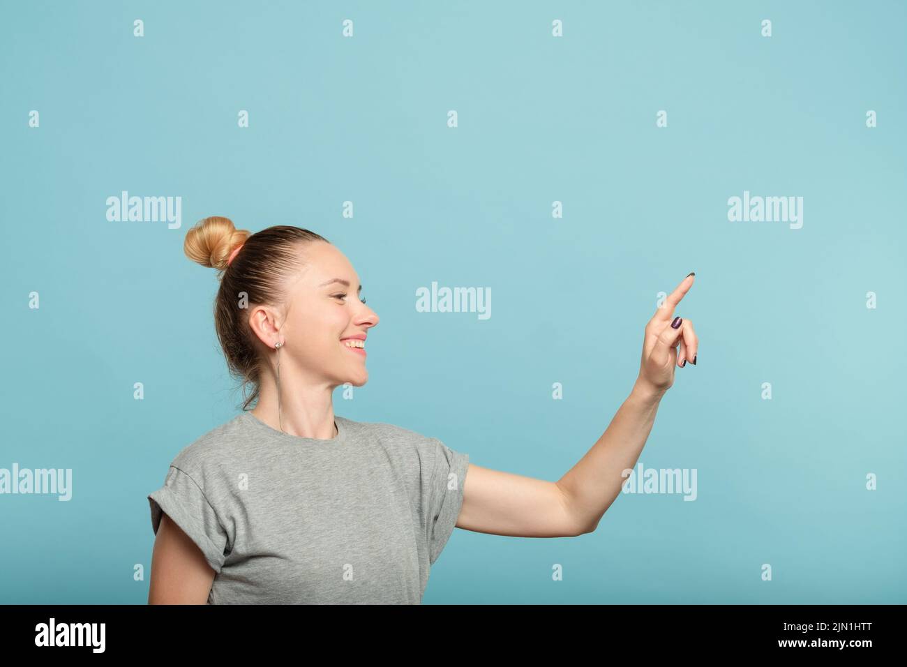 smiling woman push button virtual interface Stock Photo