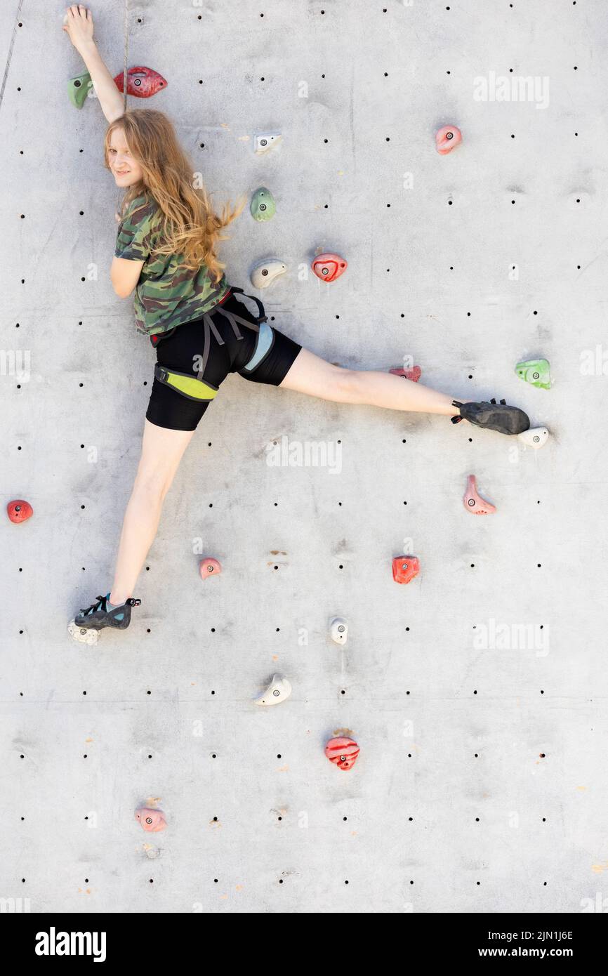 sport. bouldering, teen girl climbing up the wall Stock Photo Alamy